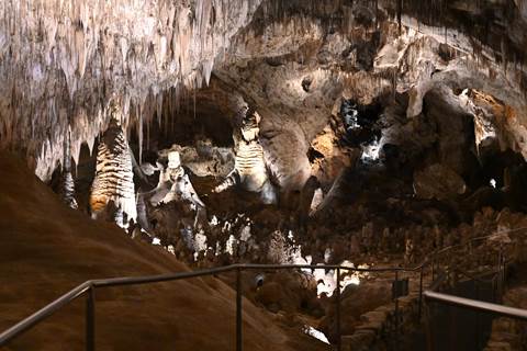 Photo of the Big Room with cave formations and the trail.