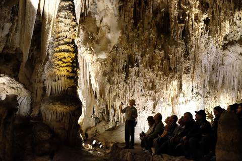 Photo of a ranger presenting a program to visitors along the King's Palace Tour.