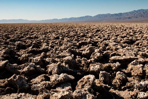 Sharp, eroded salt formations stretch into the background.