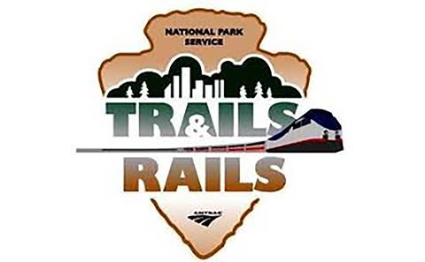 Trails & Rails logo showing the words "Trails & Rails" and an Amtrak train
